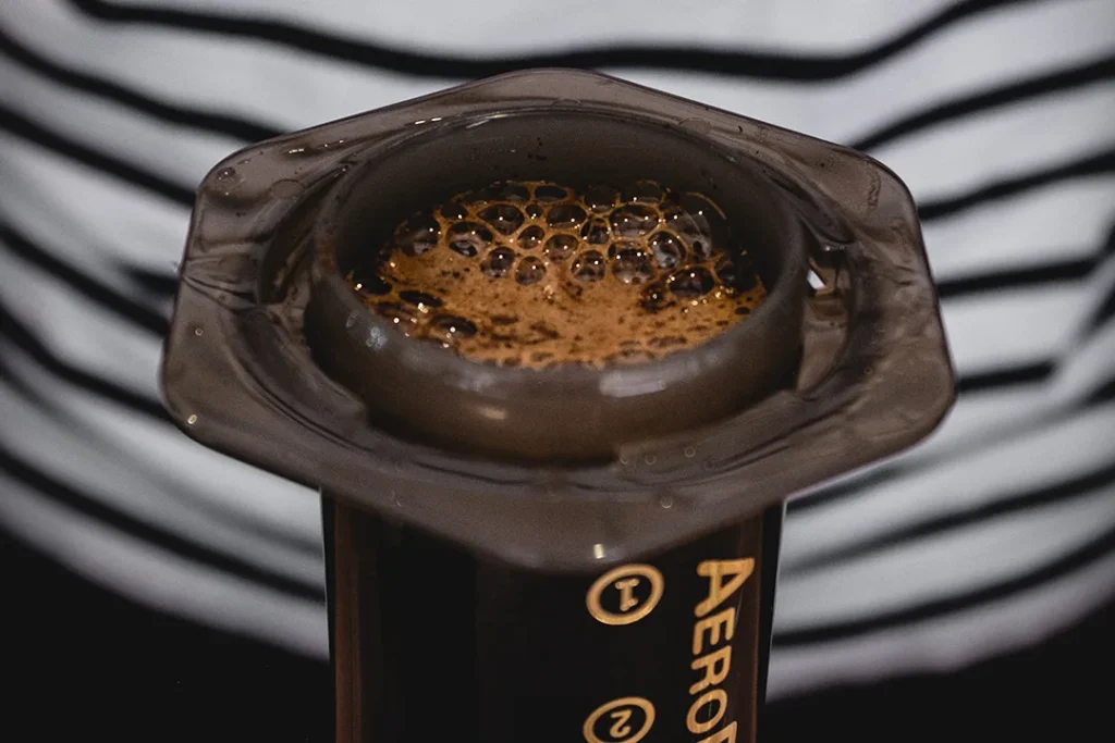 AeroPress Rezept mit Waage und frisch gebrühtem Kaffee bei Reinholz